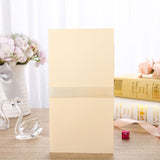 Beige box on a wooden surface with decorative items including a vase, books, and swan figurines.