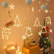 Decorative string lights with Christmas-themed decorations on a wall.