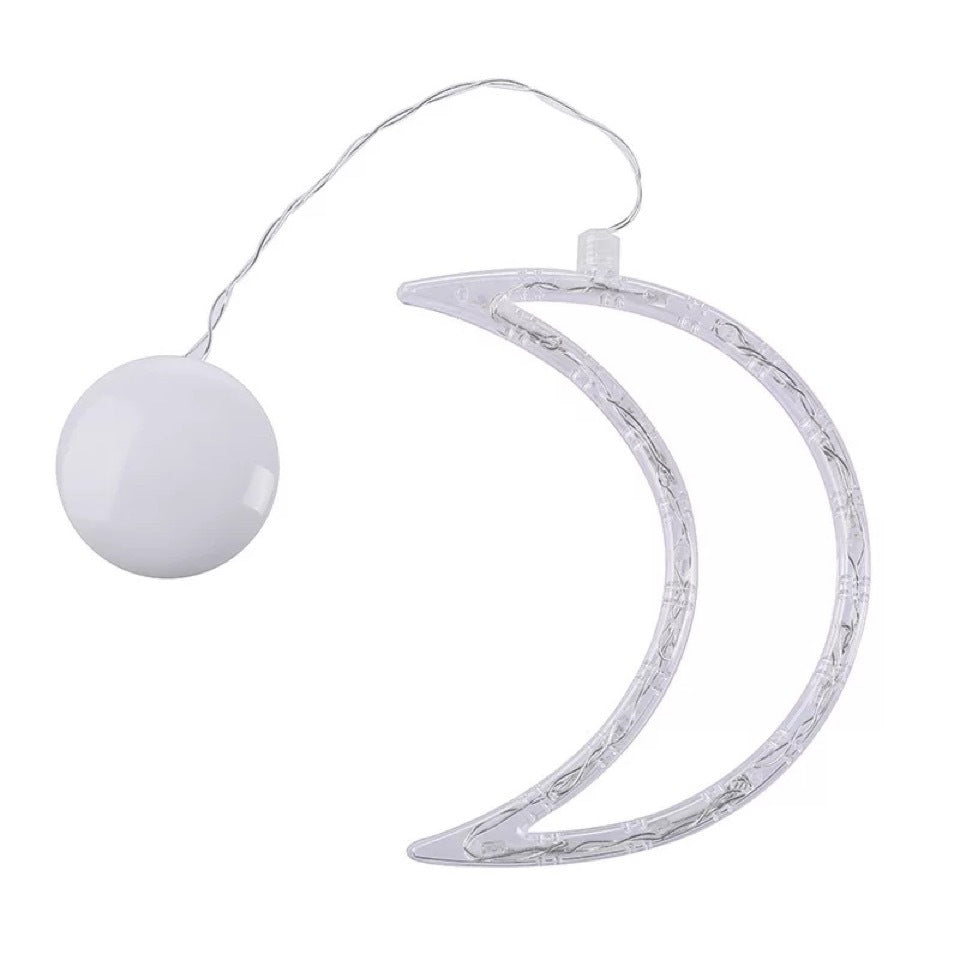 Decorative string light with a moon-shaped holder and a white ball on a white background