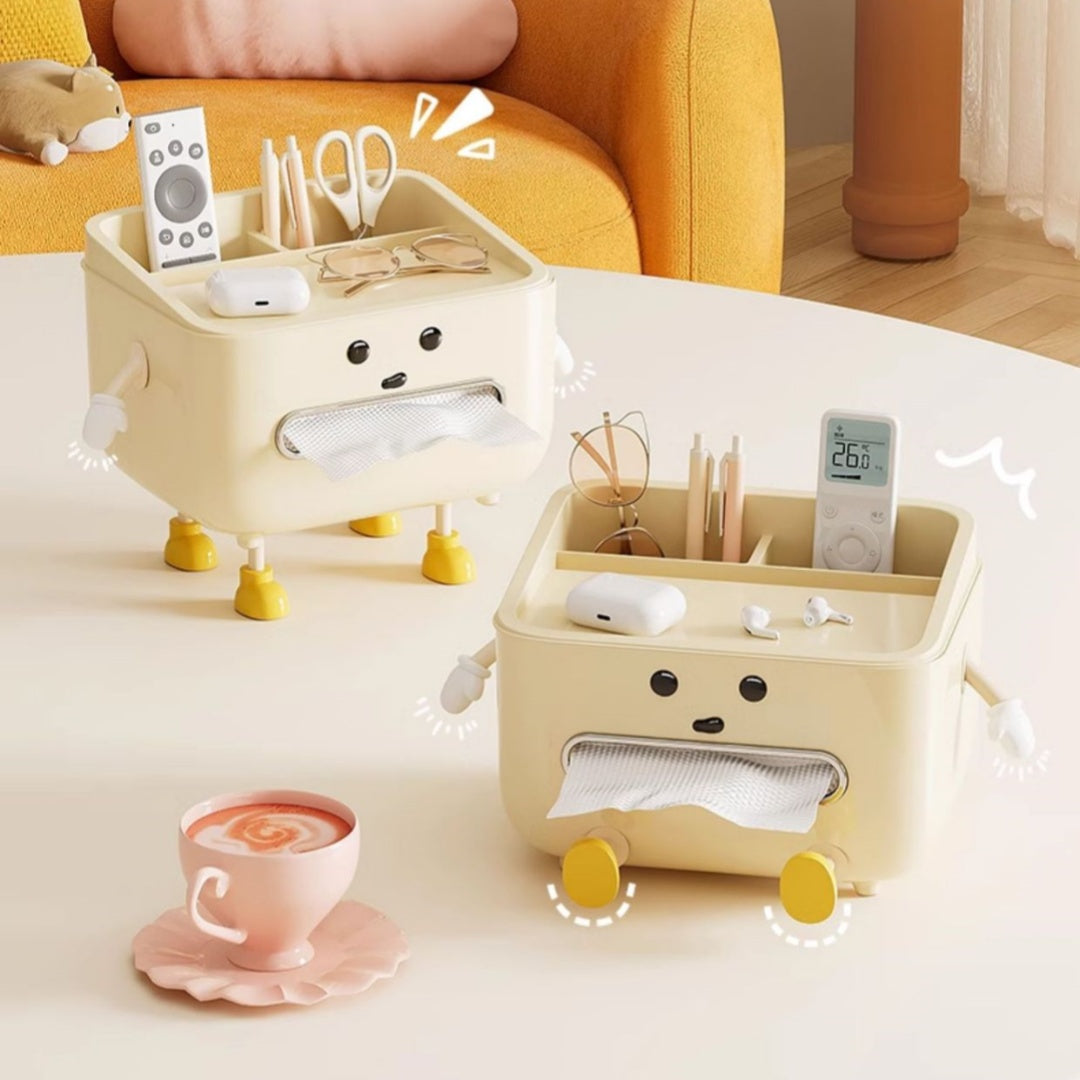 Two beige cartoon-style tissue holders with various items on a table next to a cup of coffee.