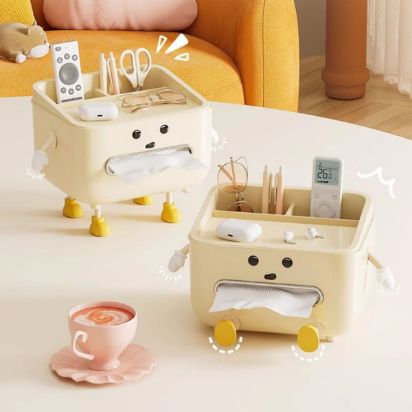 Two beige cartoon-style tissue holders with various items on a table next to a cup of coffee.