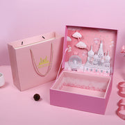Pink gift box with decorative elements on a pink background
