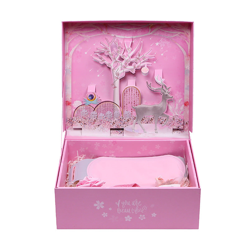 Pink toy set with deer and castle in a box on a white background