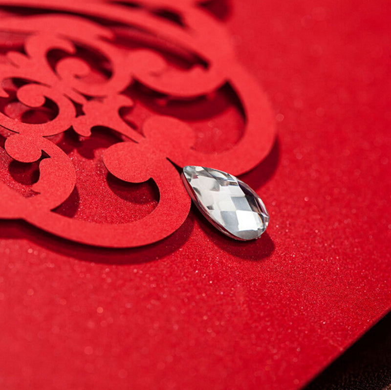 Silver teardrop earring on a red textured background