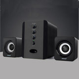 Black computer speakers with control buttons on a gray background