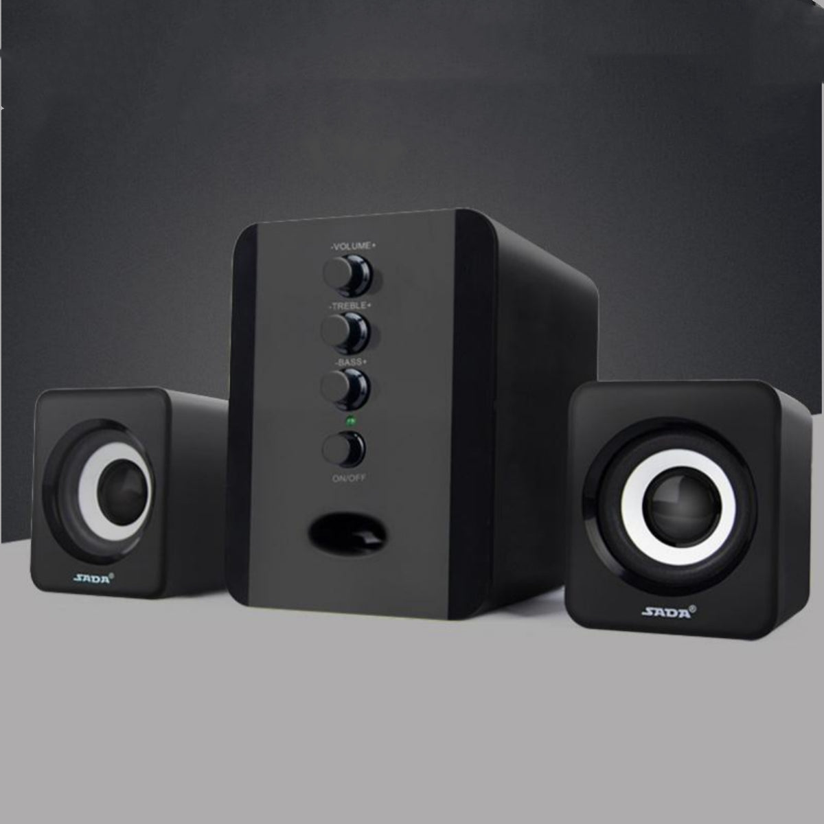Black computer speakers with control buttons on a gray background