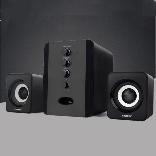 Black computer speakers with control buttons on a gray background