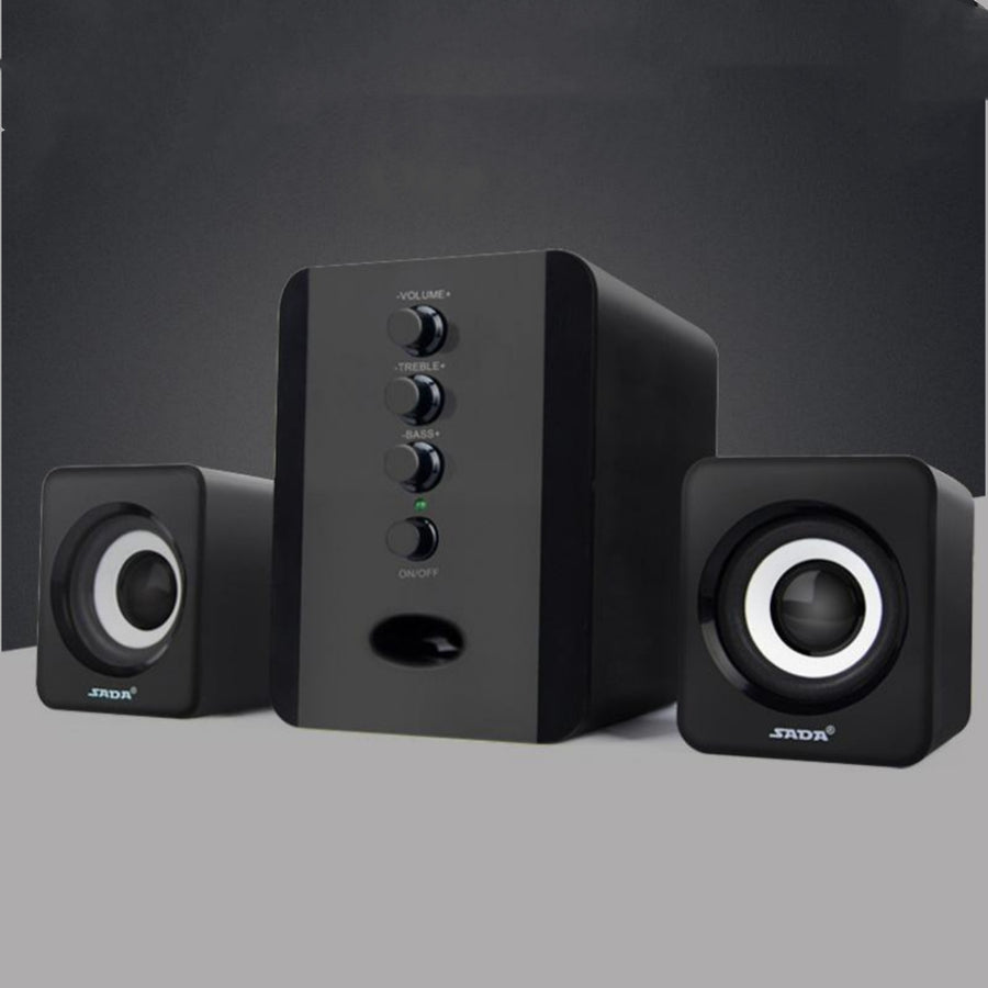 Black computer speakers with control buttons on a gray background