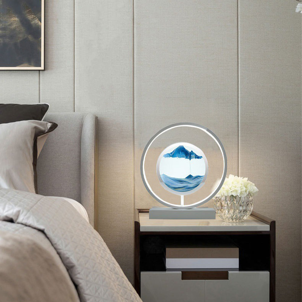 Decorative lamp on a nightstand next to a bed with a neutral color scheme