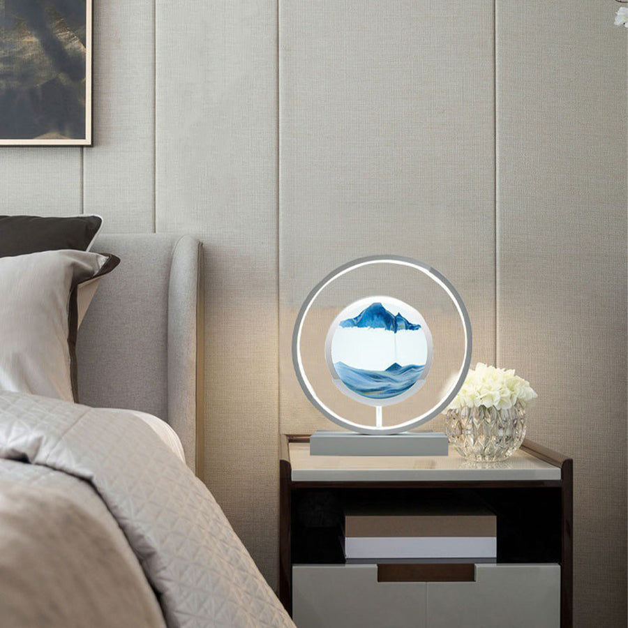 Decorative lamp on a nightstand next to a bed with a neutral color scheme