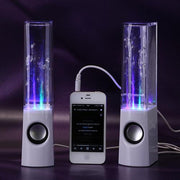 Two water fountain speakers with LED lights and a smartphone connecting them on a dark background.