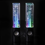 Pair of colorful water lamp speakers on a black background