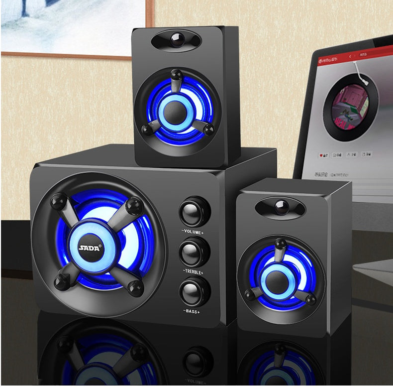 Set of black speakers with blue LED lights on a reflective surface.