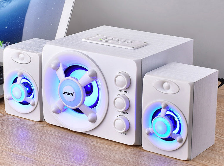 White speaker system with blue LED lights on a wooden surface