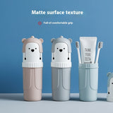 Two bear-shaped toothbrush holders and a container with toothbrushes and toothpaste on a blue background.