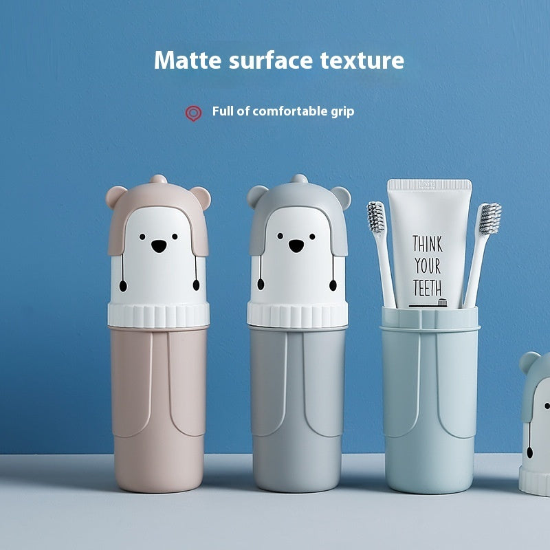 Two bear-shaped toothbrush holders and a container with toothbrushes and toothpaste on a blue background.
