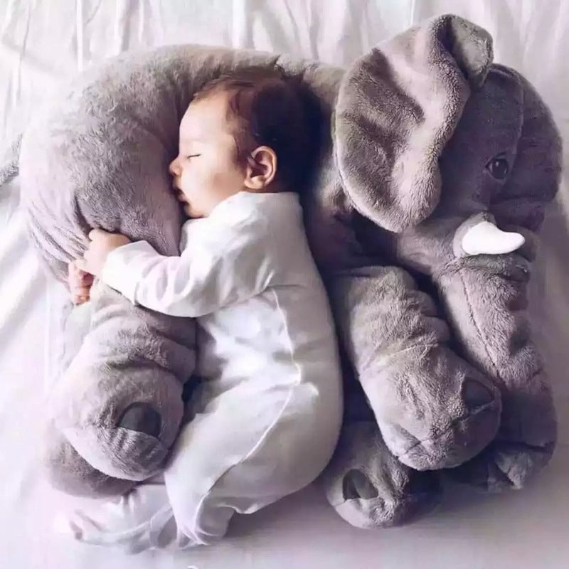 Baby sleeping with a large gray elephant plush toy