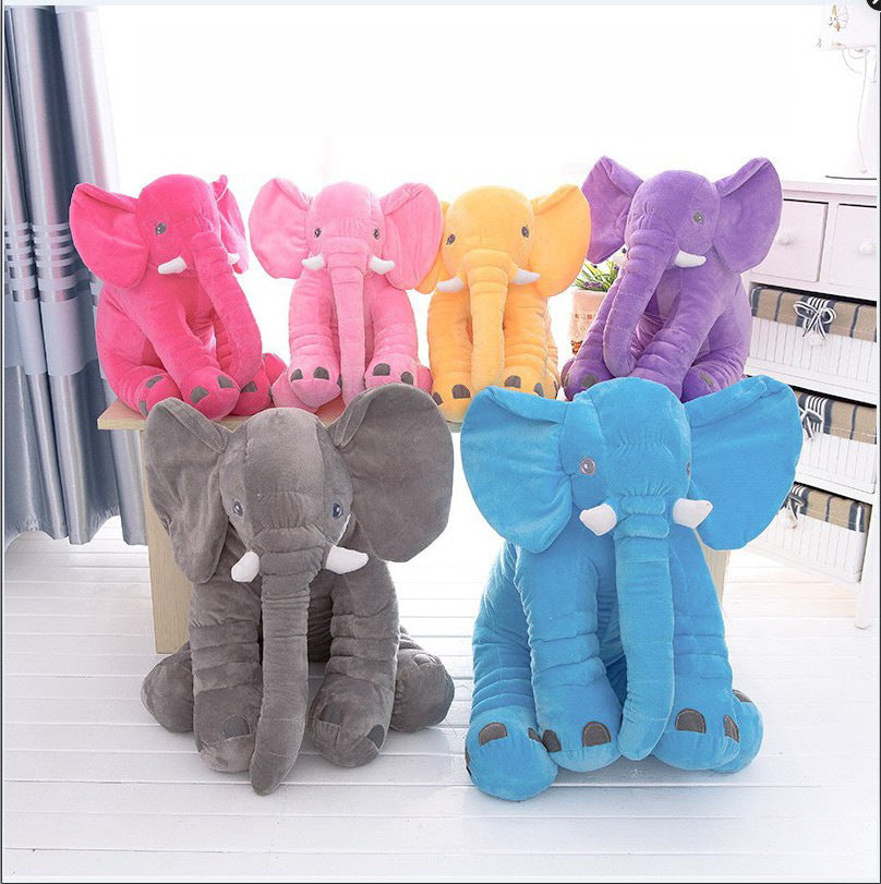 Colorful elephant plush toys on a white surface with a blurred background