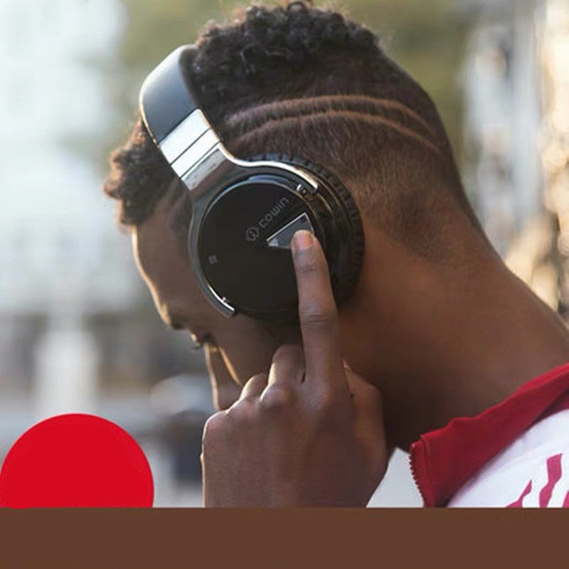 Person wearing headphones with a blurred outdoor background