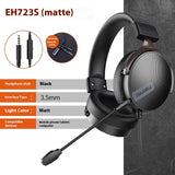 Black gaming headset with microphone on a gray background, featuring compatibility details.