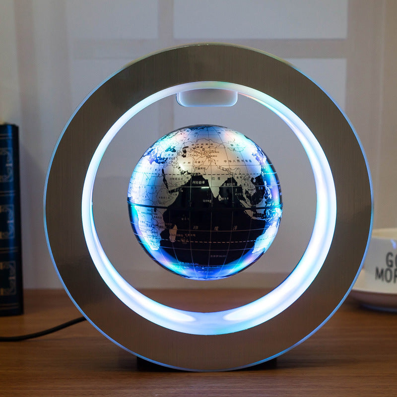 Levitating globe with LED lights on a wooden surface