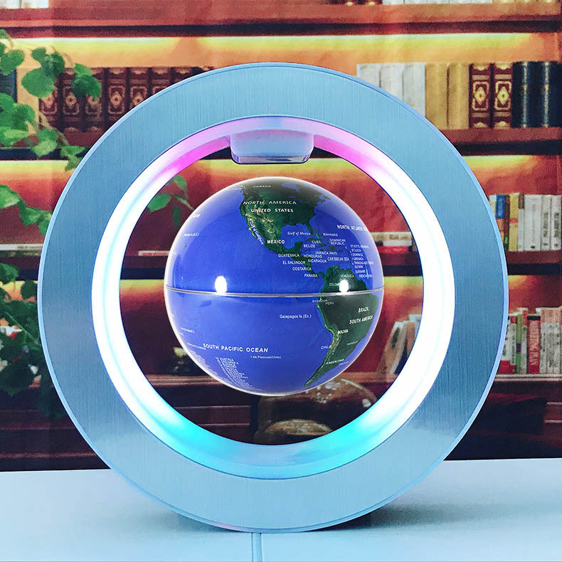 Levitating globe with LED light on a table in front of a bookshelf