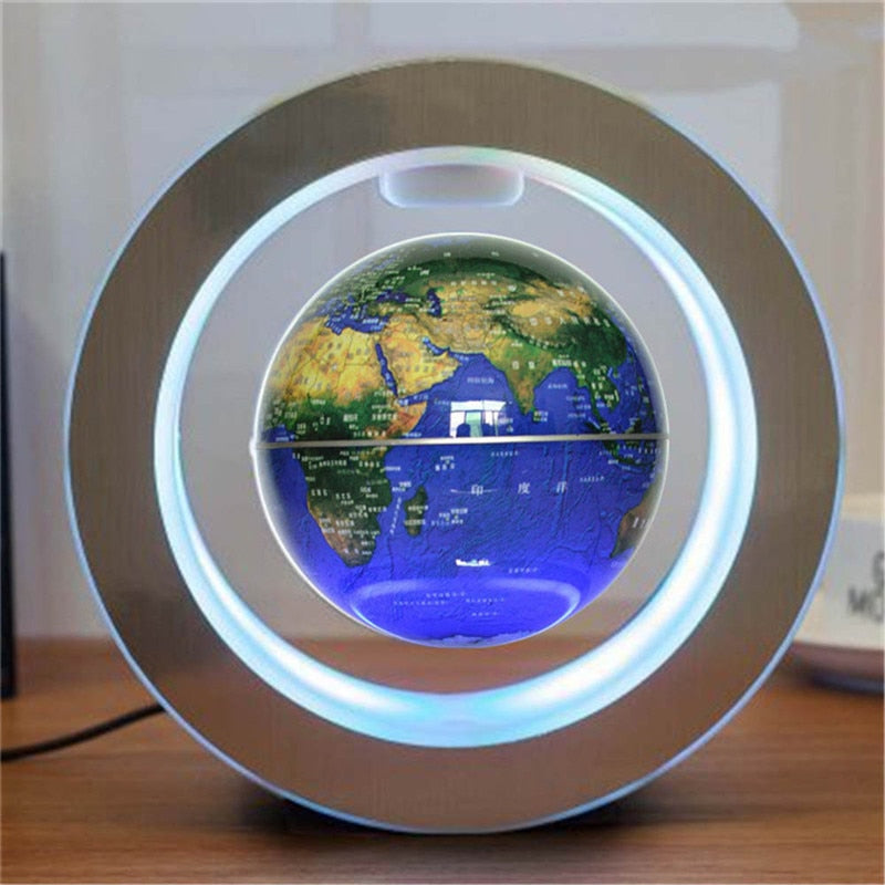 Levitating globe with LED lighting on a wooden surface