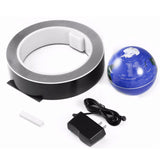 Roll of tape, blue ball, power adapter on a white background