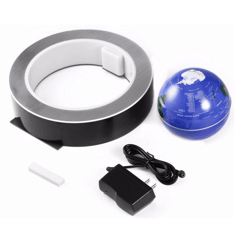 Roll of tape, blue ball, power adapter on a white background
