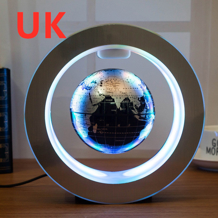 Levitating globe with LED lights on a wooden surface, featuring the text 'UK' in red.