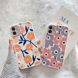 Two floral phone cases held by a person against a light background