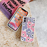 Two phone cases on a textured surface with a book in the background.