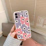 Phone case with floral pattern held by a person indoors