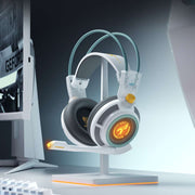 Gaming headset on a stand with a computer monitor in the background