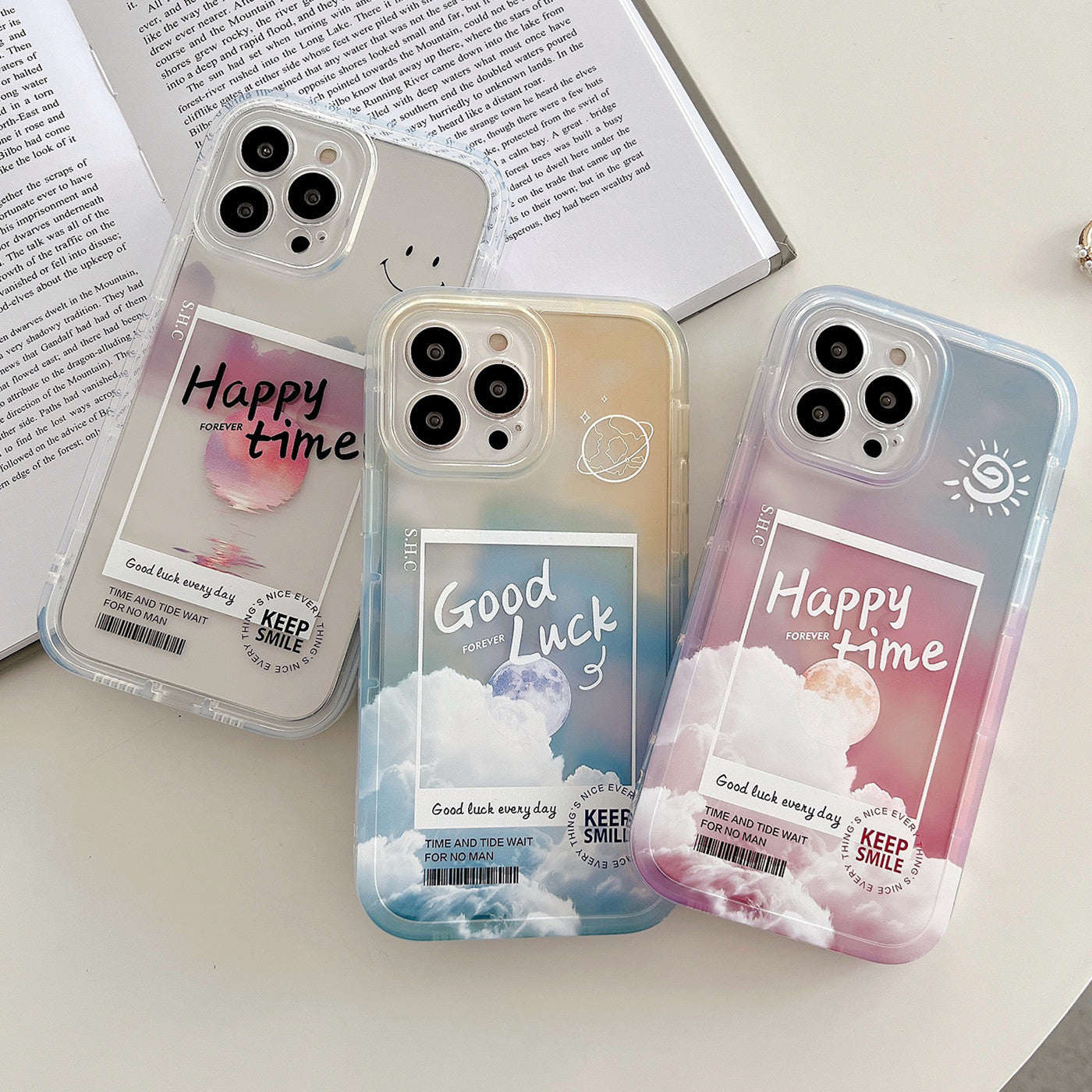 Three phone cases with motivational phrases on a surface