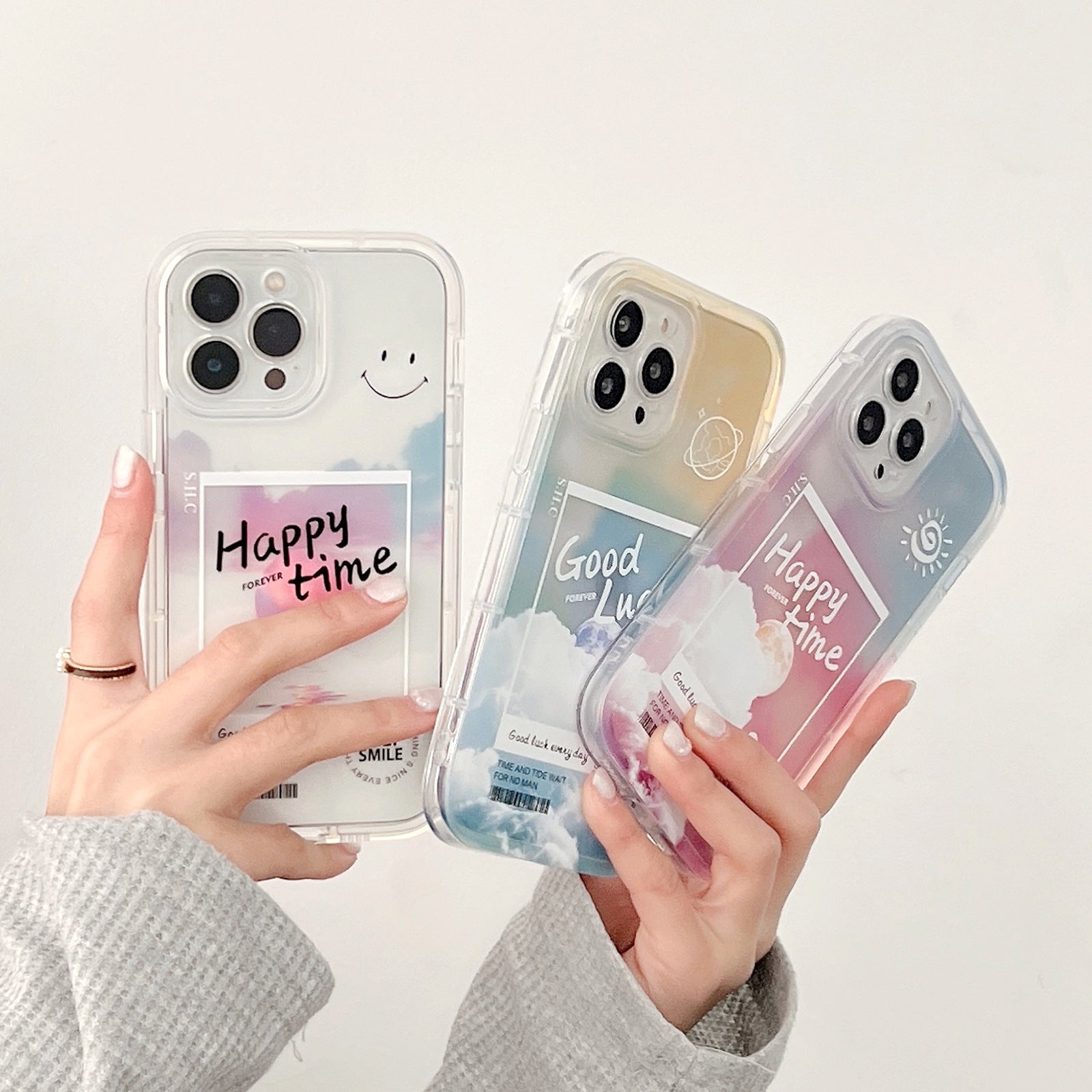 Three phone cases with motivational phrases held by a person against a white background