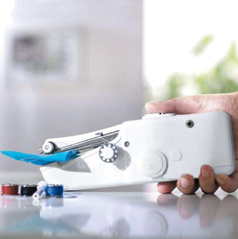 Hand holding a white sewing machine with blue accents on a reflective surface.
