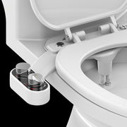 Close-up of a toilet seat with a water tank attachment on a black background