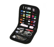 Sewing kit with various tools and threads in a black case on a white background