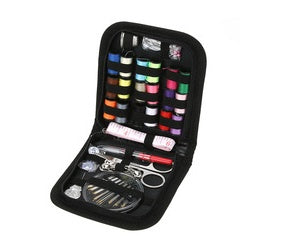 Sewing kit with various tools and threads in a black case on a white background