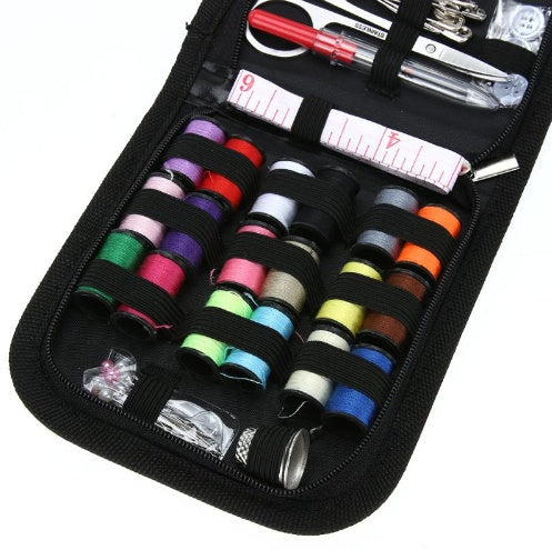 Sewing kit with colorful thread spools and tools in a black case