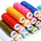 Assorted colorful spools of thread on a white background