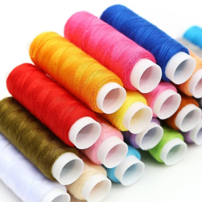 Assorted colorful spools of thread on a white background