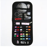 Sewing kit with various tools including scissors, needles, and thread in a black case on a white background.