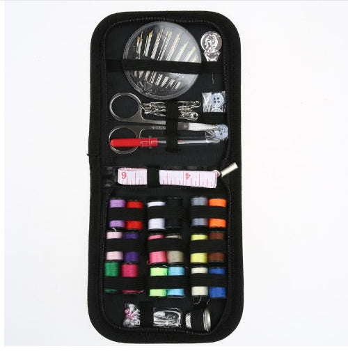 Sewing kit with various tools including scissors, needles, and thread in a black case on a white background.