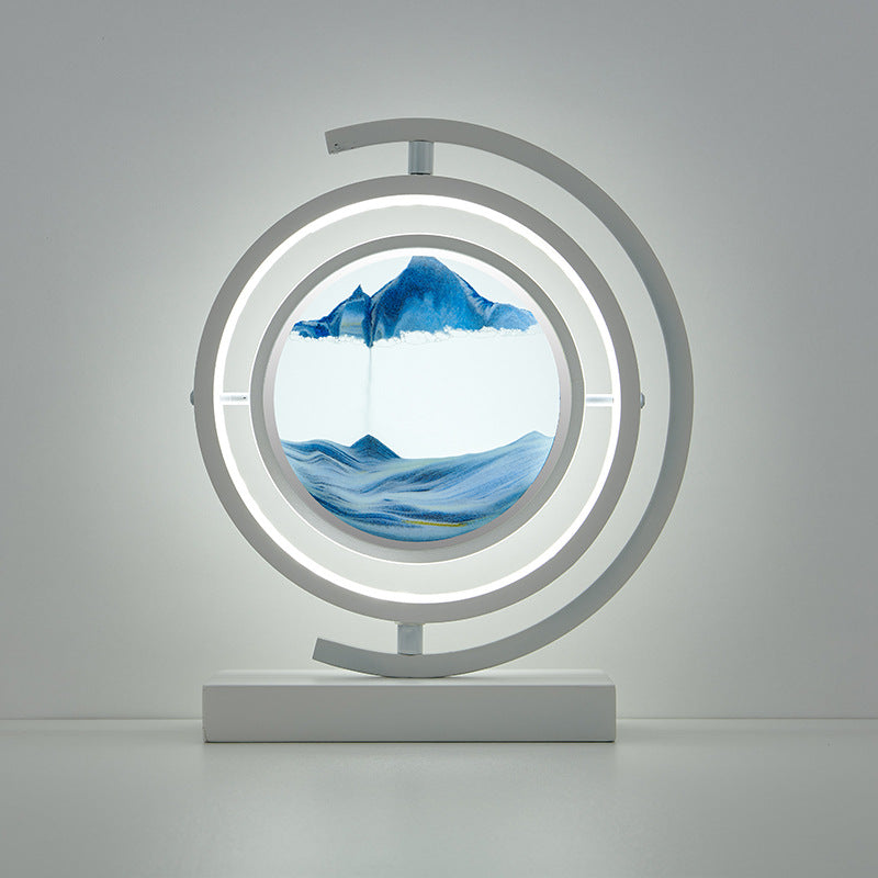 Decorative lamp with circular design featuring a mountain and wave illustration on a gray background