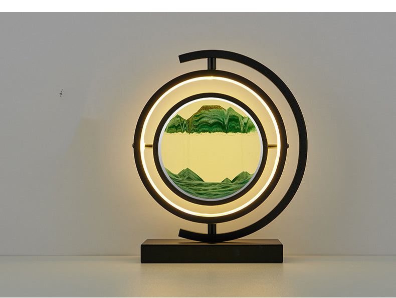 Decorative lamp with circular design and mountain landscape on a plain background