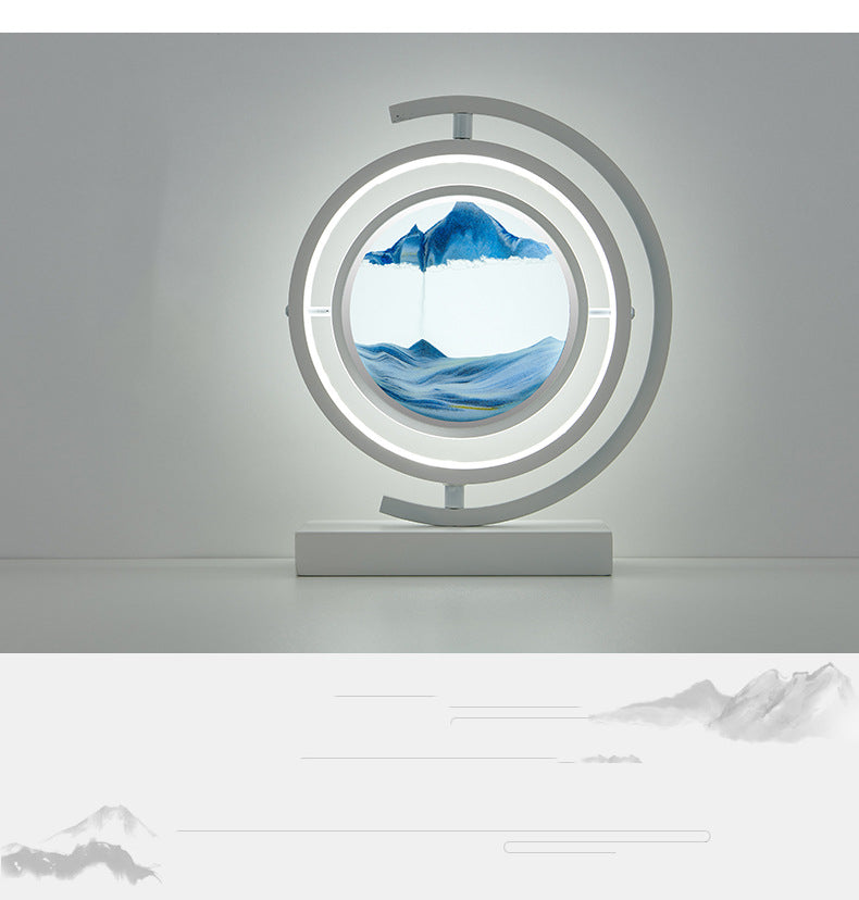 Decorative lamp with circular design featuring mountain and water scene on a gray background