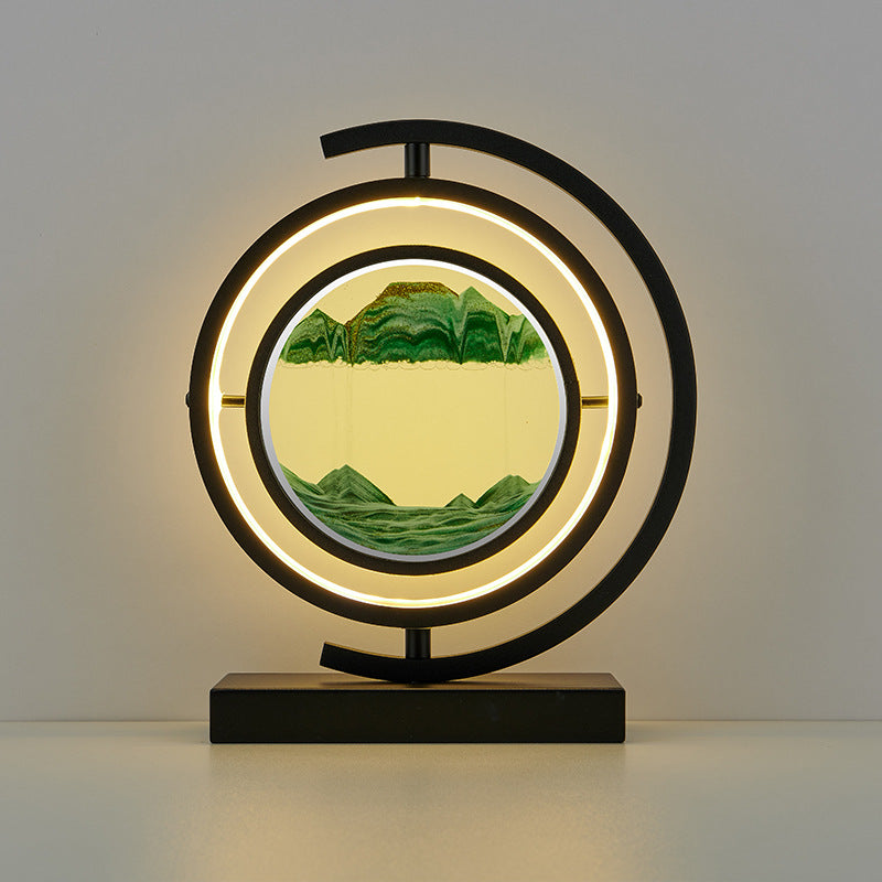 Decorative lamp with circular design and mountain landscape inside, on a plain background