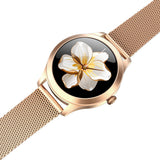 Rose gold watch with floral design on the face against a white background